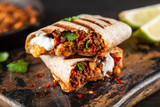 Fototapeta Konie - Mexican burrito with beef, beans and sour cream