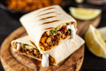 Wall Mural - Mexican burrito with beef, beans and sour cream