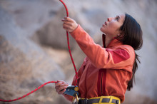 Young Woman Belaying With Rope
