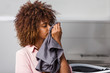 © Samuel B. - Young black African American woman washing her clothes in a automatic laundry