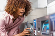 © Samuel B. - Young black African American woman washing her clothes in a automatic laundry