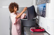 © Samuel B. - Young black African American woman washing her clothes in a automatic laundry
