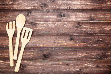 Wall Mural - Wooden kitchen cutlery on brown table