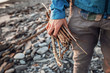 © Cavan Images - Close up of man holding bunch of wooden sticks