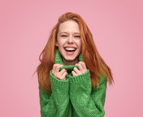 bright laughing teenage girl on pink background