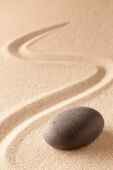 Poster - black round zen meditation stone for focus and concentration in Japanese sand garden. Textured background with copy space for mindfulness or spa wellness.