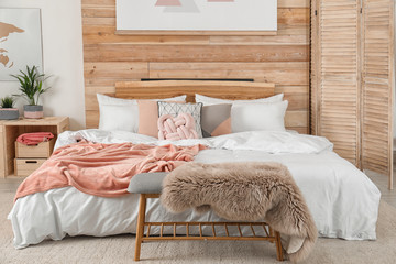 Wall Mural - Stylish room interior with comfortable bed near wooden wall