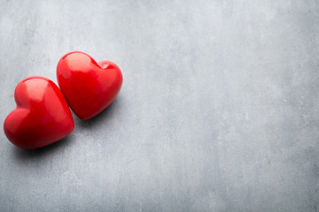 Red heart on the gray metal background.