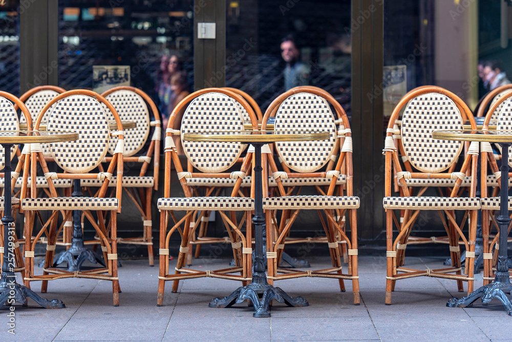 Rows of traditional Chairs of a Street Cafe in France, french furniture in a Street  - obrazy, fototapety, plakaty 