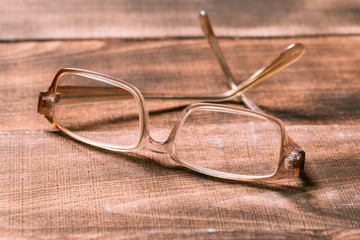 Wall Mural - old glasses on wooden surface