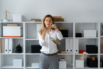 young businesslady in office make good bargain have big profit fling money