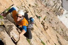 A Man Rock Climbing On The Diamond, Rocky Mountain National Park, Estes Park, Colorado.