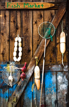 Buoys, Fishing Nets And Sign On Old Wooden Barn