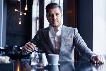 Canvas Print - Business man drinking coffee in a cafe - coffee time.