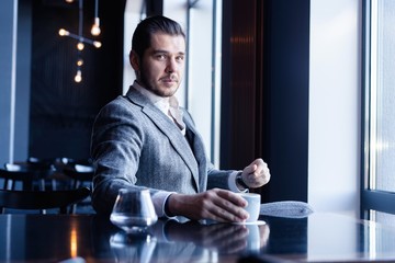 Canvas Print - Business man drinking coffee in a cafe - coffee time.