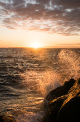 wave splashing over rocks near Melbourne in australia at sunset