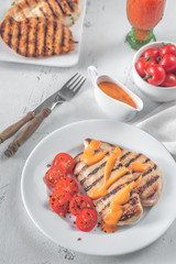 Wall Mural - Grilled chicken breast with sauce and cherry tomatoes