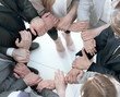 © ASDF - group of employees forming a circle out of hands