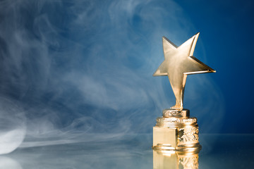 gold star in smoke, blue background
