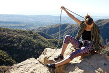 A Female Climber Stacks Her Rope While Sitting On Top Of Lower Gibraltar Rock In Santa Barbara, California.  Lower Gibraltar Rock Provides Great Vistas Of Santa Barbara And The Pacific Ocean.