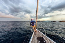 Man Standing On Bow Of Yacht, Lombok, Indonesia