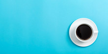 A Coffee Cup On A Blue Paper Background