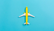 A Toy Airplane On A Blue Paper Background