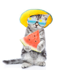 Tiny kitten with mirrored sunglasses and summer hat holds watermelon. isolated on white background