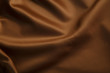 Smooth elegant brown silk or satin texture can use as abstract background. Luxurious background design wallpaper