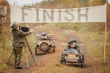 Wall Mural - Finish the race between the boys on self-made cars