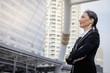 © Nuchylee - Successful senior caucasian businesswoman leader standing over modern building background