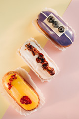 Wall Mural - Set of delicious eclairs with glaze, colorful dessert