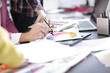 © yurolaitsalbert - close up.designer working at office Desk with blueprints for a new project