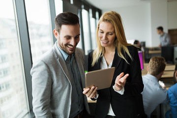 Wall Mural - Businesspeople discussing while using digital tablet in office