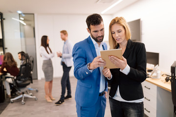 Sticker - Businesspeople discussing while using digital tablet in office