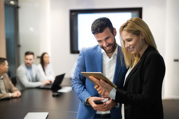 Wall Mural - Businesspeople discussing while using digital tablet in office