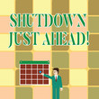 Text sign showing Shutdown Just Ahead. Business photo showcasing closing factory business either short time or forever Businessman Smiling and Pointing to Colorful Calendar with Star Hang on Wall