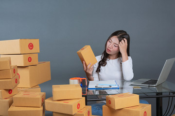 Men and women are helping to pack the boxes.