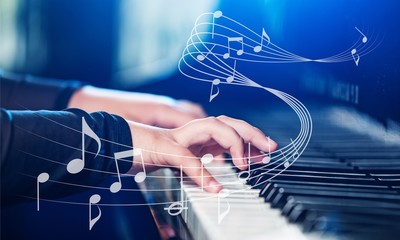 Wall Mural - Close up of a musician playing a piano keyboard