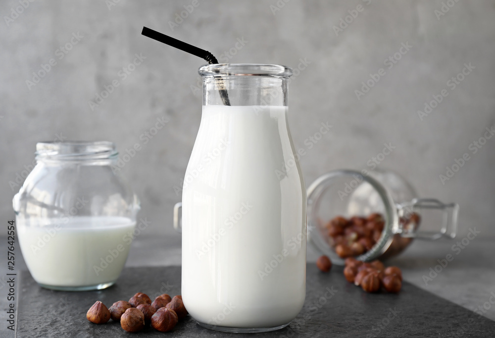 Bottle of healthy hazelnut milk on table