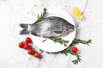 Plate with fresh fish on table