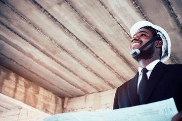 Wall Mural - African engineer man architect looking at construction project