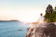 © Eskymaks - Young Man Meditating on beach.