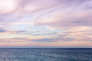 Gorgeous dusk seascape cloudscape rolling over open water.