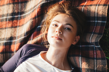 Poster - Top view of a lovely young teenage girl laying on a blanket