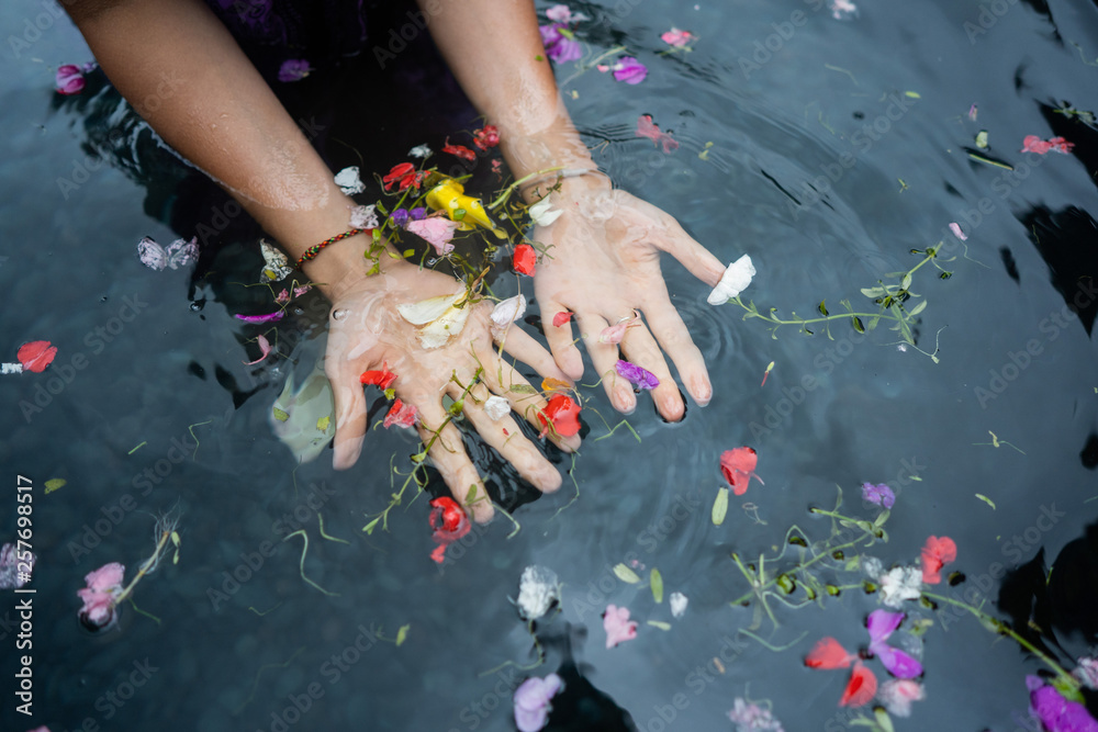 girl's hands on bali holy springs - obrazy, fototapety, plakaty 