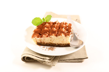 Wall Mural - delicious tiramisu cake portion on white background