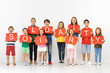 © master1305 - Solidarity of sweet hearts. Group of happy screaming children, young team or teenagers with a red banners isolated in white studio background. Education and advertising concept