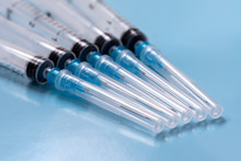 Several Syringes On A Blue Background. Vaccinations.