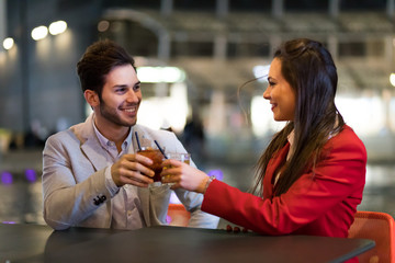 Friends toasting glasses outdoor at night